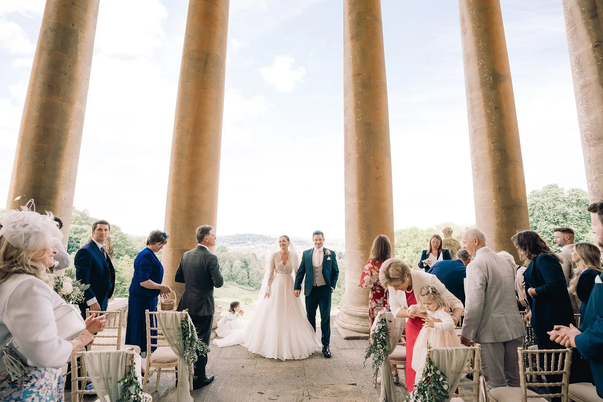 Newlyweds walk hand in hand after their ceremony at Prior Park captured in elegant Bath wedding photography
