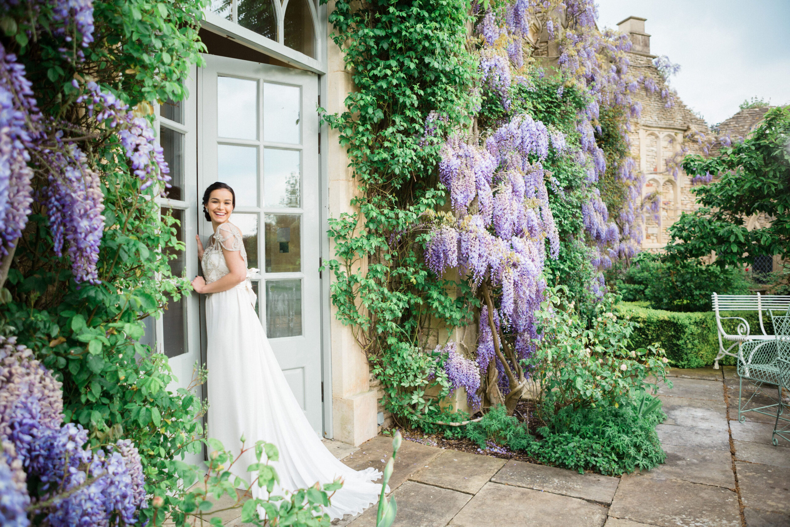 Bride stands by wisteria doorway at Euridge Manor | Euridge Manor wedding photographer
