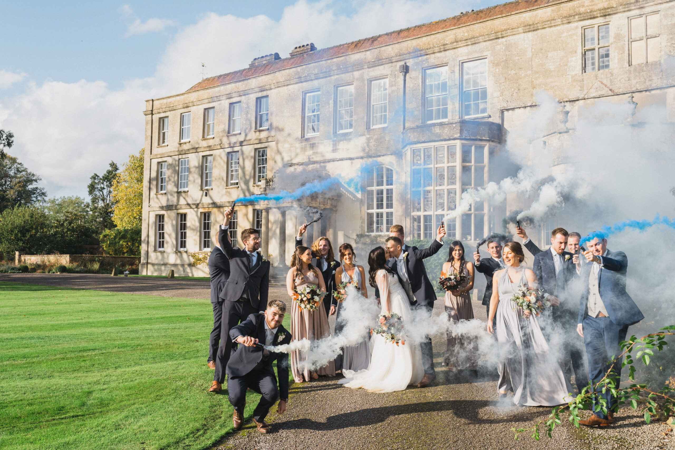 Wedding party celebrates with blue smoke bombs at Elmore Court | Gloucestershire wedding photographer