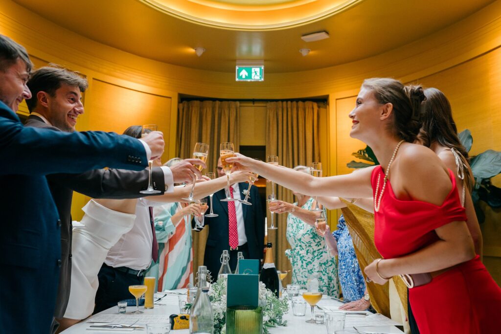 Wedding guests raising glasses during Bath wedding dinner