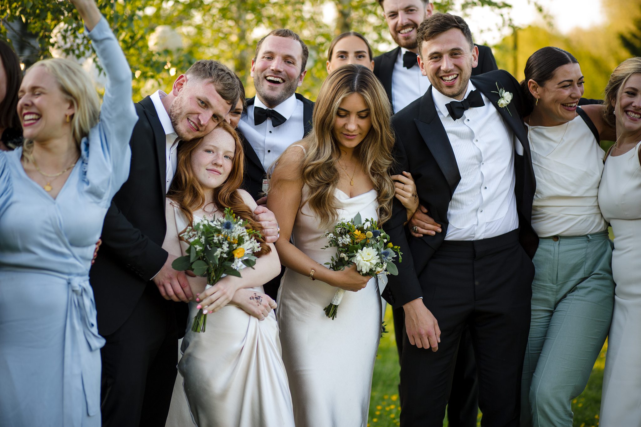 wedding party laughing together at a cotswold marquee celebration