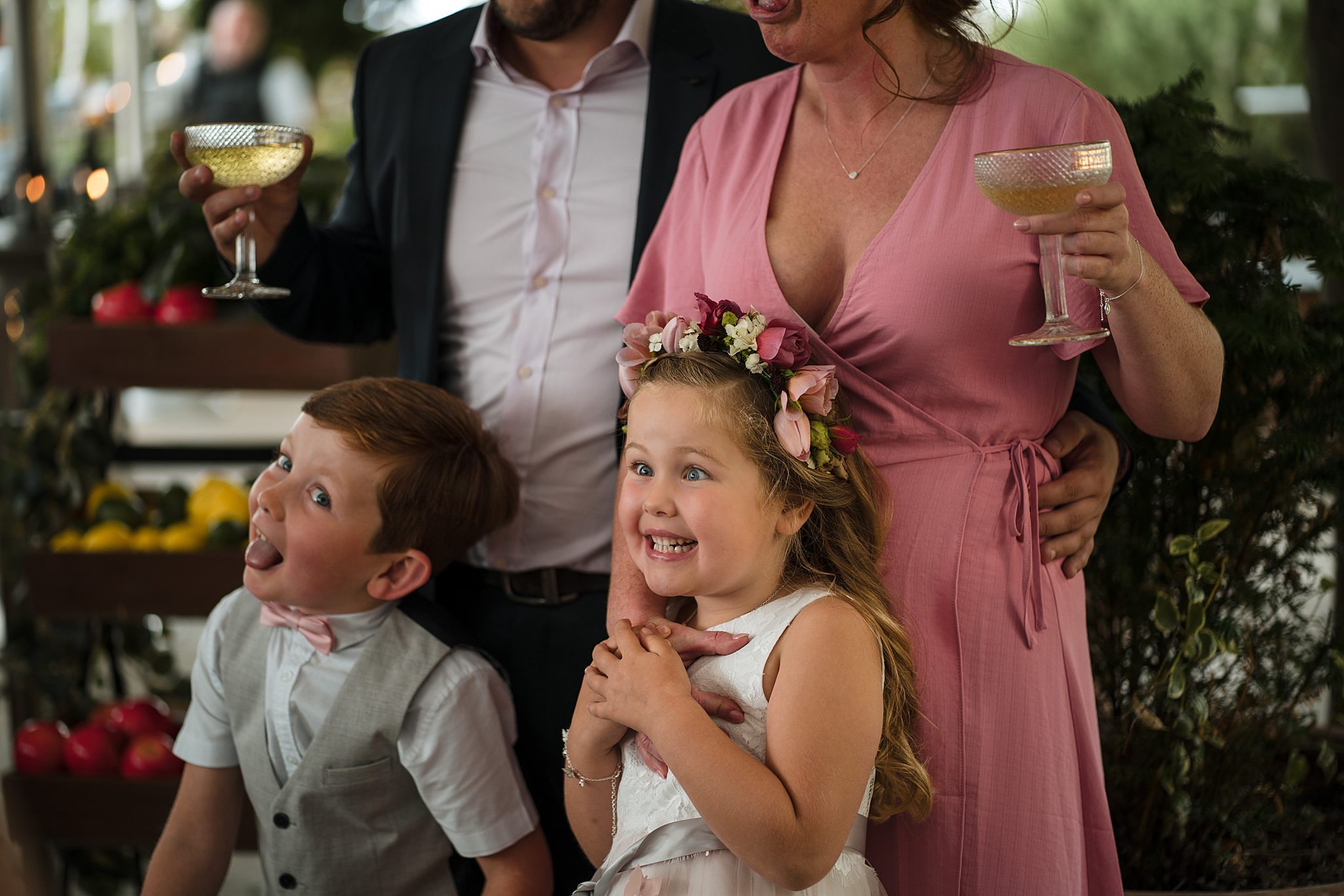 Children laugh during family celebration at Cheltenham wedding.