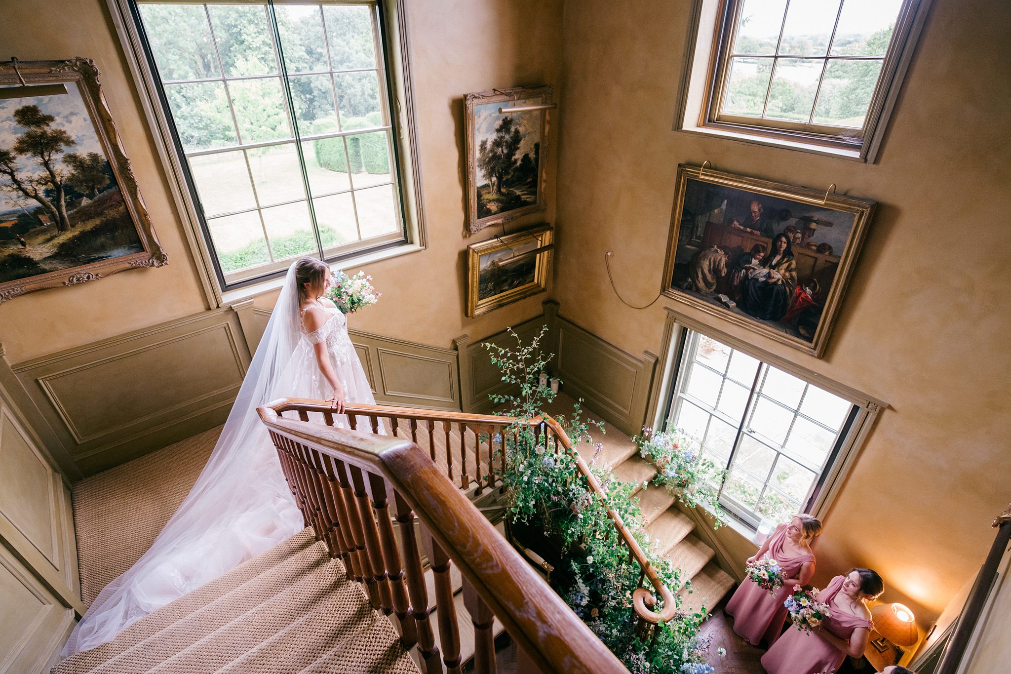 bride walks down the staircase at pauntley court